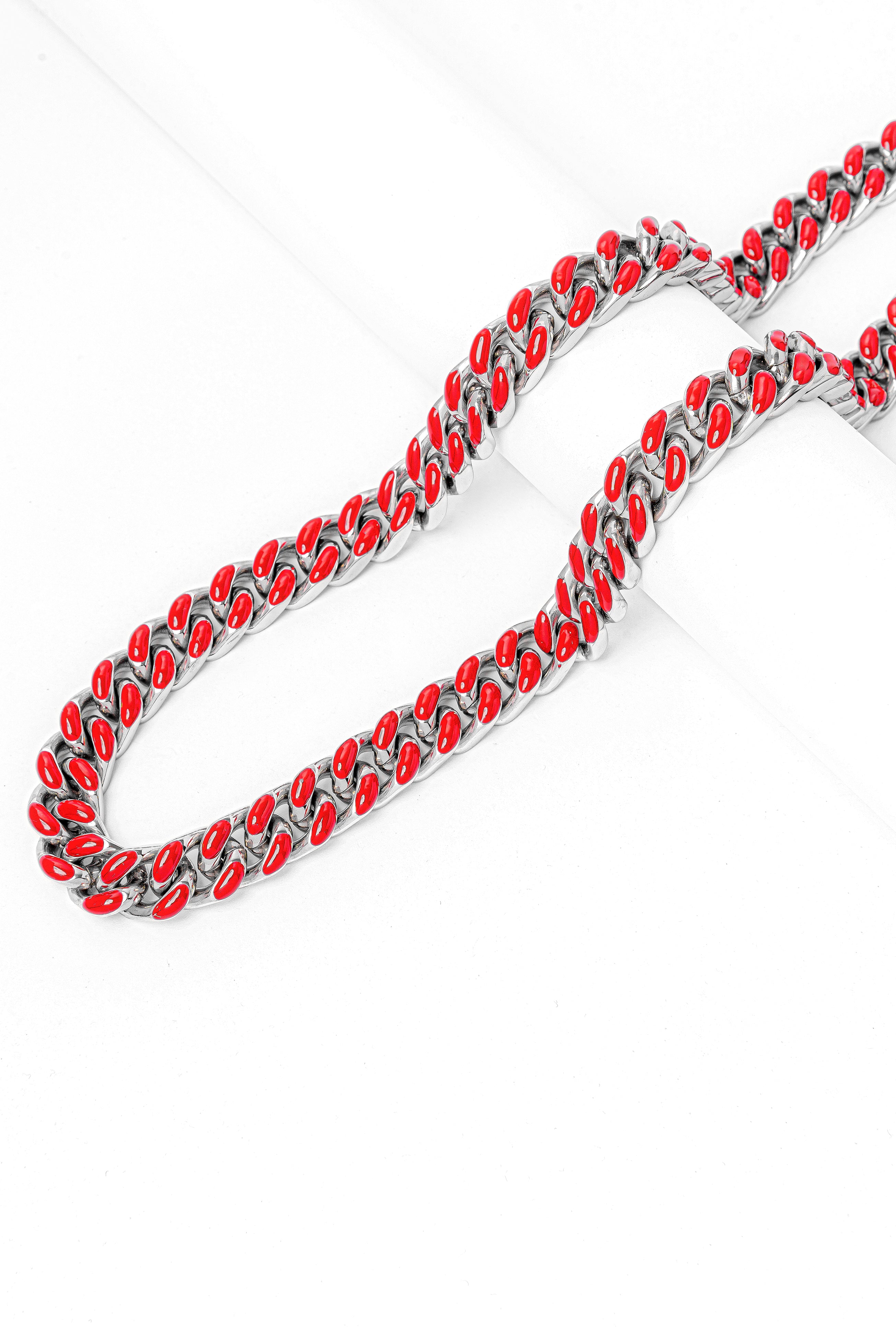 Two Big Daddy 13MM red enamel Cuban chains displayed