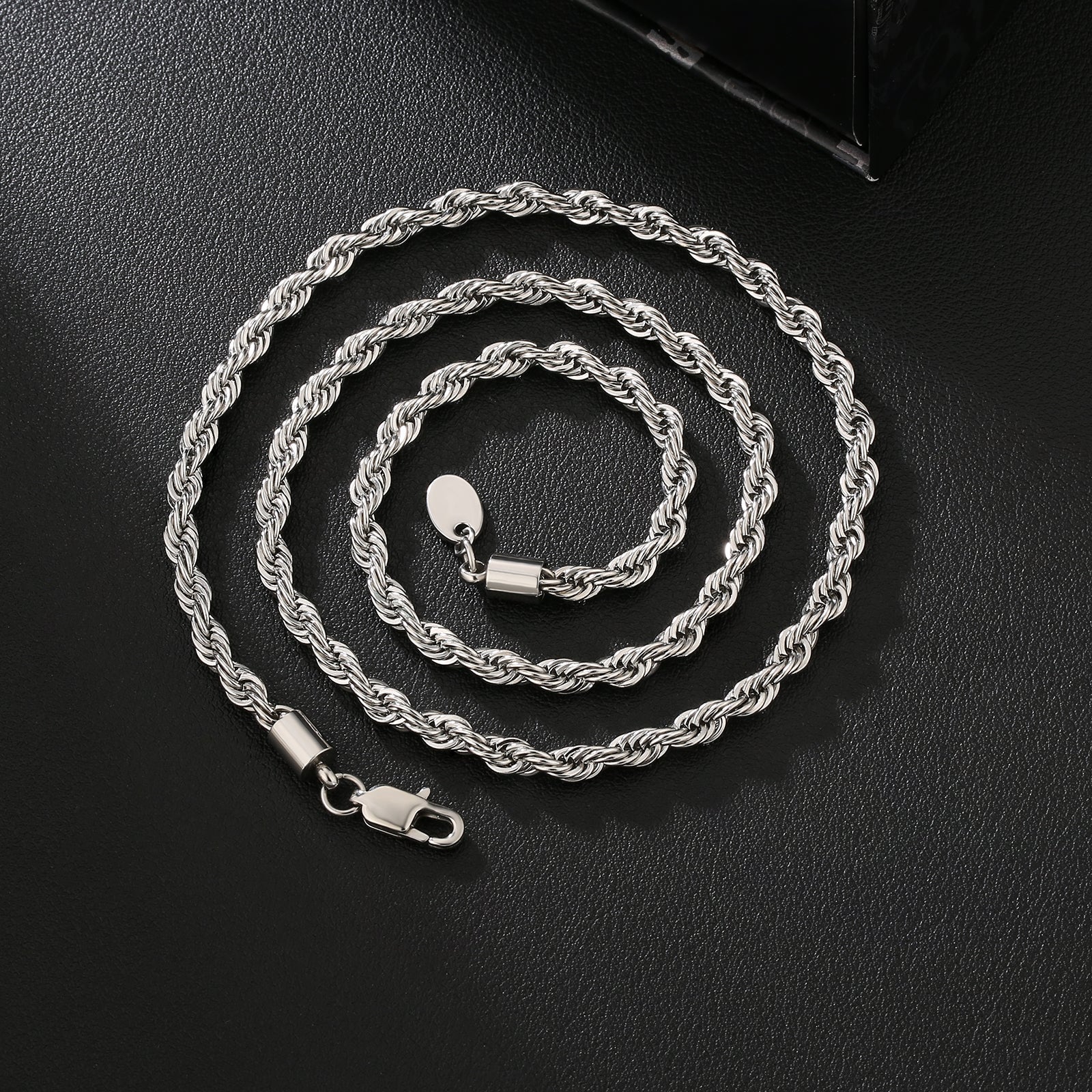 Close-up of 4mm silver rope chain layout showing twisted rope texture and clasp
