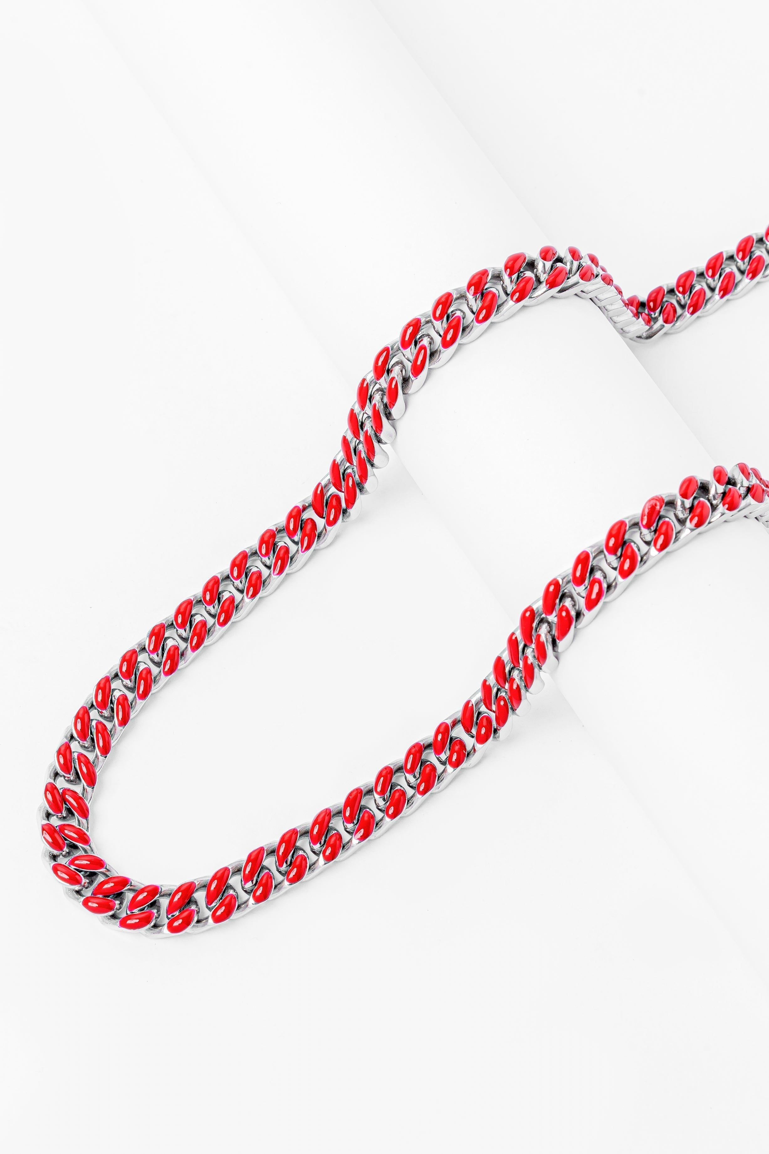 Red enamel Cuban chain angled view showing link pattern and texture