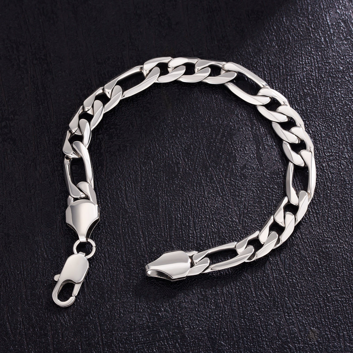 9mm Figaro steel bracelet with open lobster clasp on dark textured surface