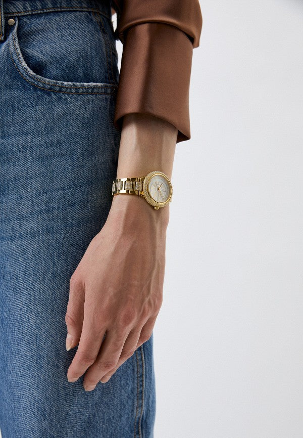 Michael Kors Taryn gold-tone watch worn on wrist with mother-of-pearl dial