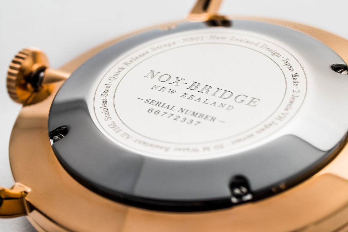 Caseback of Noxbridge Classic Capella watch showing serial number and brand engraving on gray case